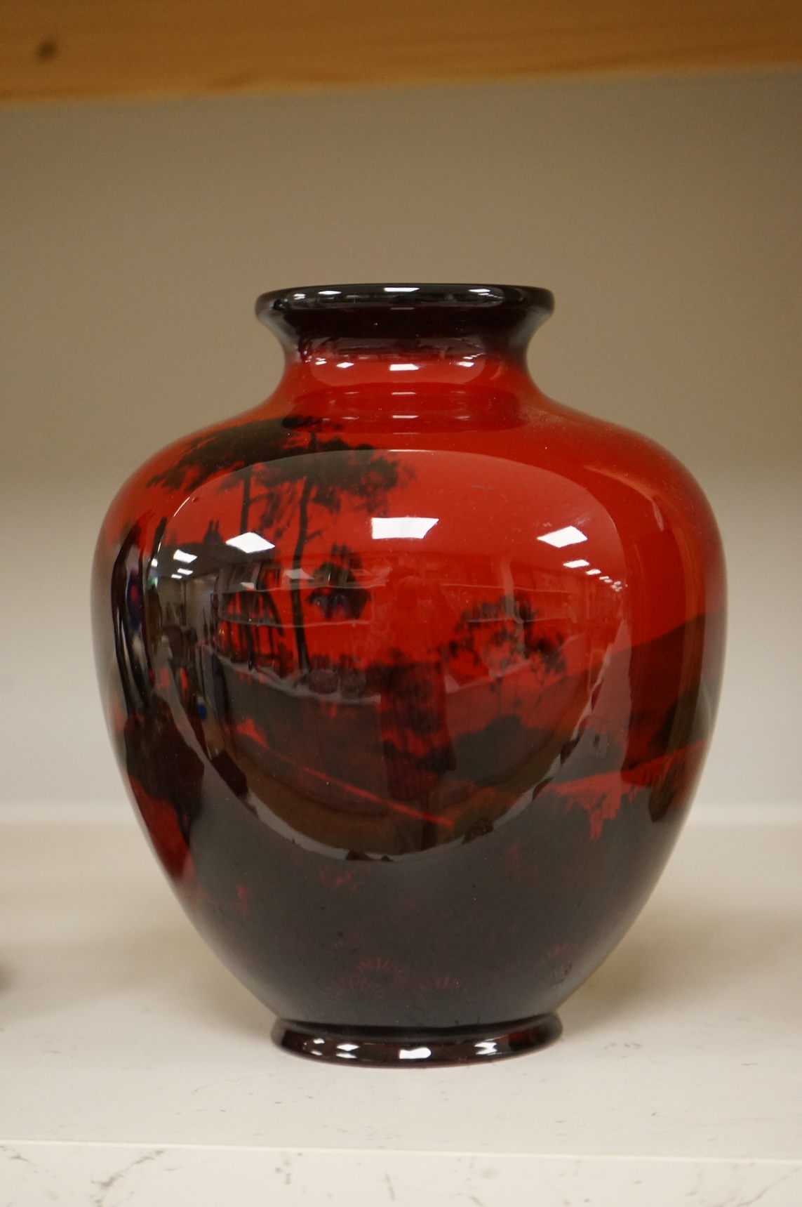 A Royal Doulton flambé vase decorated with a landscape, 19cm high